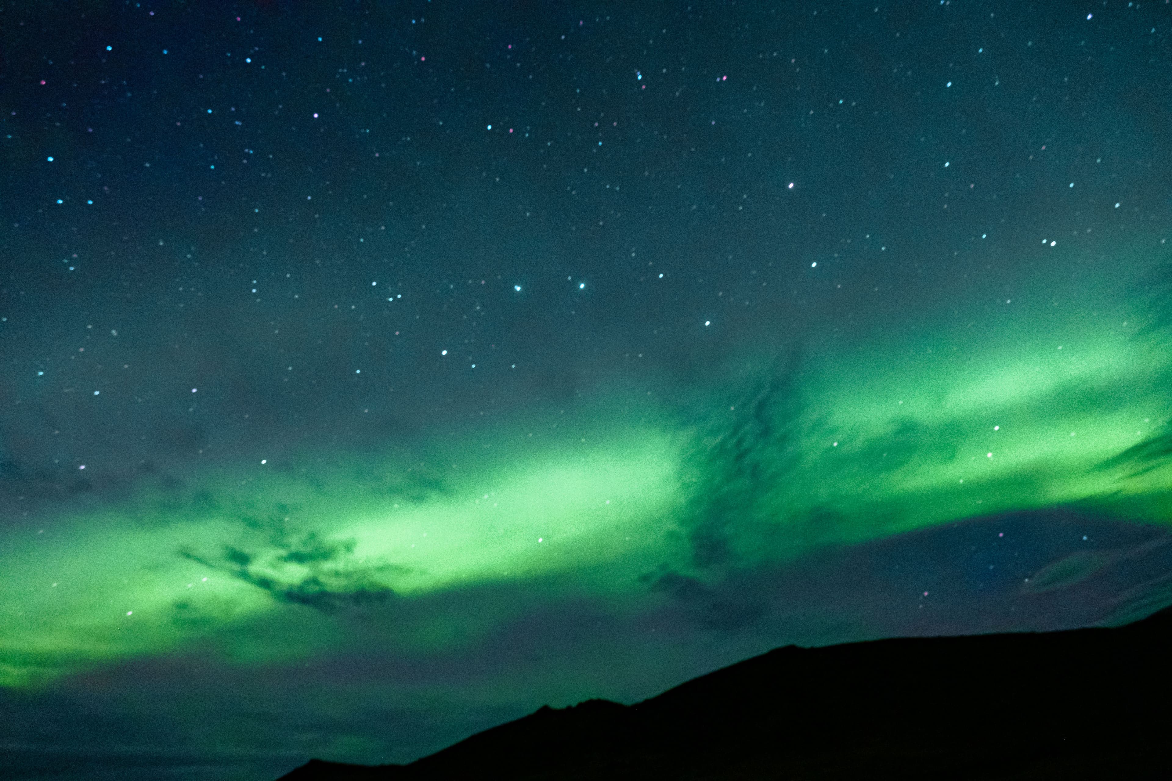 Green aurora in a dark night sky